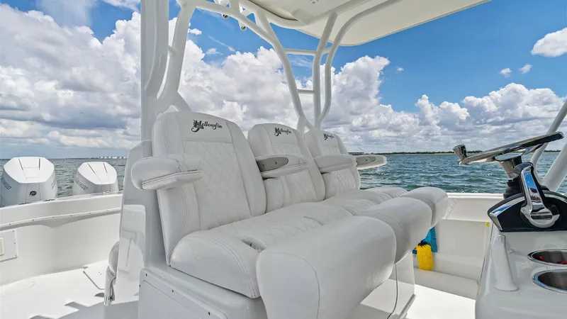 Slide: The Image of Helm Seating and Console View This image showcases the helm seating area of the 2014 Yellowfin 39 Center Console. The plush, white upholstered seats offer comfort and style, complemented by a sturdy framework for support. The console is equipped with state-of-the-art controls, ensurin - 7943321