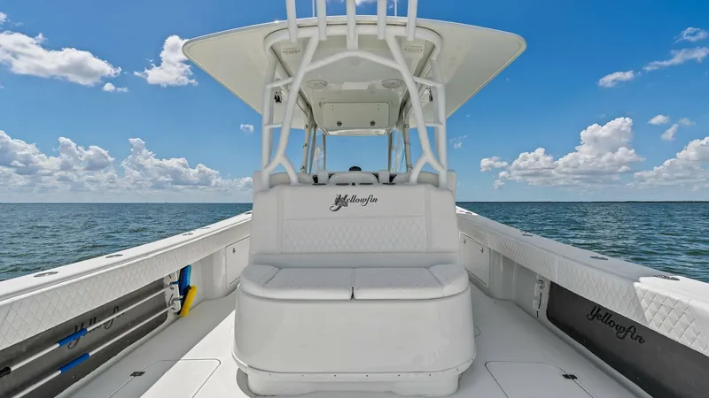 Slide: The Image of Center Console Seating Area This image showcases the spacious seating area at the center console of the 2014 Yellowfin 39 Center Console. The sleek, white upholstery complements the modern design, providing both comfort and style. With ample space and a protective overhead canopy, t - 7943309