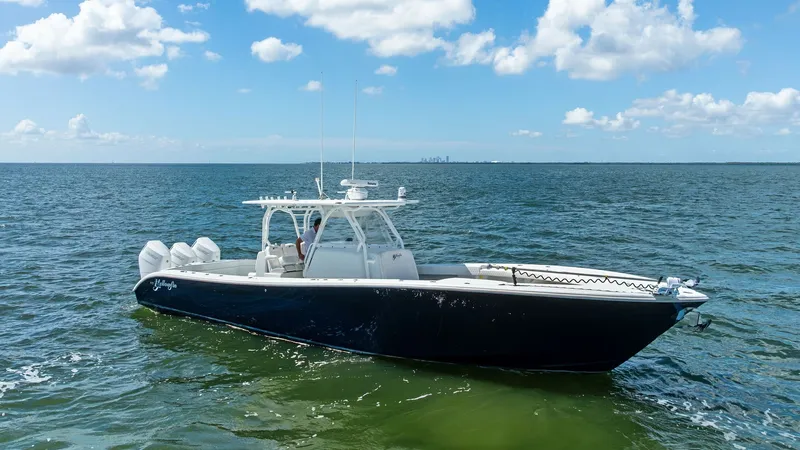 Slide: The Image of Side View of 39 Center Console This image showcases the sleek profile of the 2014 Yellowfin 39 Center Console, highlighted by its deep blue hull and white topside. The spacious deck is designed for optimal functionality, making it ideal for both fishing and leisure. With powerful outbo - 7943349