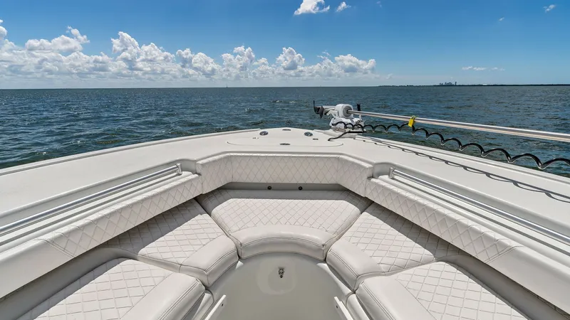 Slide: The Image of Bow Seating Area with Ocean View This image showcases the spacious bow seating area of the 2014 Yellowfin 39 Center Console. The plush, diamond-stitched upholstery offers ample comfort, surrounded by sleek, durable railings. Perfect for relaxation, the open ocean view enhances the appeal - 7943331