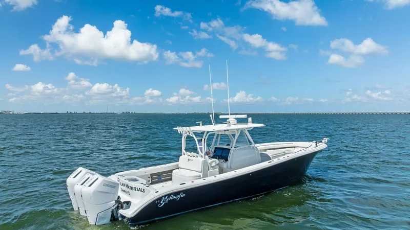 Slide: The Image of Aerial View of Center Console This image showcases the sleek 2014 Yellowfin 39 Center Console gliding gracefully on the water. The boat features a spacious deck layout, perfect for fishing and leisure, complemented by sturdy T-top protection. Twin powerful outboard engines promise an - 7943351