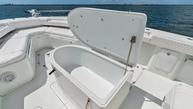 Slide: The Image of Bow Fish Box Storage Open This image showcases the spacious fish box storage on the bow of the 2014 Yellowfin 39 Center Console. The open hatch reveals a deep, insulated compartment designed for keeping your catch fresh. The surrounding seating area features diamond-stitched uphol - 7943335