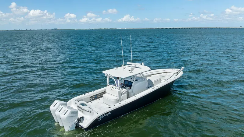 Slide: The Image of Aerial View of Center Console This 2014 Yellowfin 39 Center Console boasts a sleek, open deck design ideal for fishing and leisure. The image highlights the spacious layout, including a T-top for shade and twin outboard engines for powerful performance. The clean lines and sturdy cons - 7943352