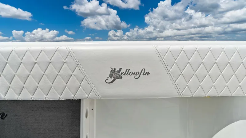 Slide: The Image of Yellowfin Branded Upholstered Detail The image showcases a close-up of the Yellowfin's exquisite upholstery on the 39 Center Console. The diamond-stitched pattern adds a touch of luxury and elegance, complemented by the prominently displayed Yellowfin logo. This detail highlights the brand's - 7943307