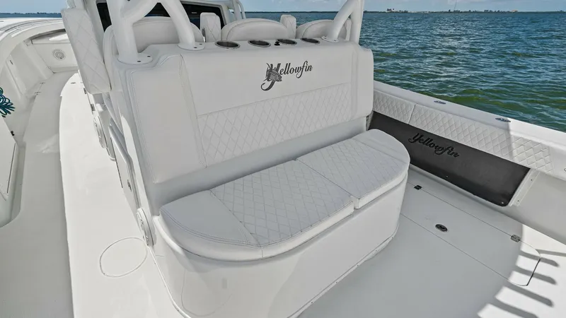 Slide: The Image of Aft Deck Seating Area The 2014 Yellowfin 39 Center Console features a spacious aft deck with comfortable, diamond-stitched seating. The sleek white upholstery complements the elegant design, providing a perfect spot for relaxation while cruising. This area offers unobstructed - 7943314