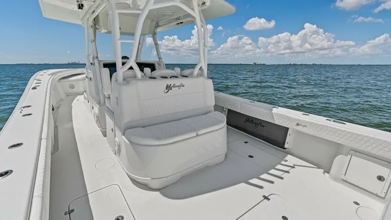 Slide: The Image of Spacious Aft Deck with Seating The aft deck of the 2014 Yellowfin 39 Center Console offers ample seating and open space, perfect for socializing or fishing. The sleek white finish and well-cushioned seats provide both comfort and style. This area features practical design elements, inc - 7943311