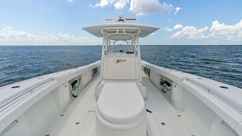 Slide: The Image of Spacious Forward Deck Seating Area This 2014 Yellowfin 39 Center Console showcases a spacious forward deck with ample seating. The sleek design features comfortable, cushioned bench seats and a center console equipped with advanced navigation systems. Perfect for both relaxation and high-p - 7943340