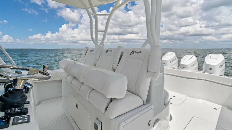 Slide: The Image of Helm Seating and Console View This image showcases the helm seating area of the 2014 Yellowfin 39 Center Console. The plush, white upholstered seats offer comfort and style, complemented by the sleek design of the console. The open layout provides excellent visibility and accessibilit - 7943317