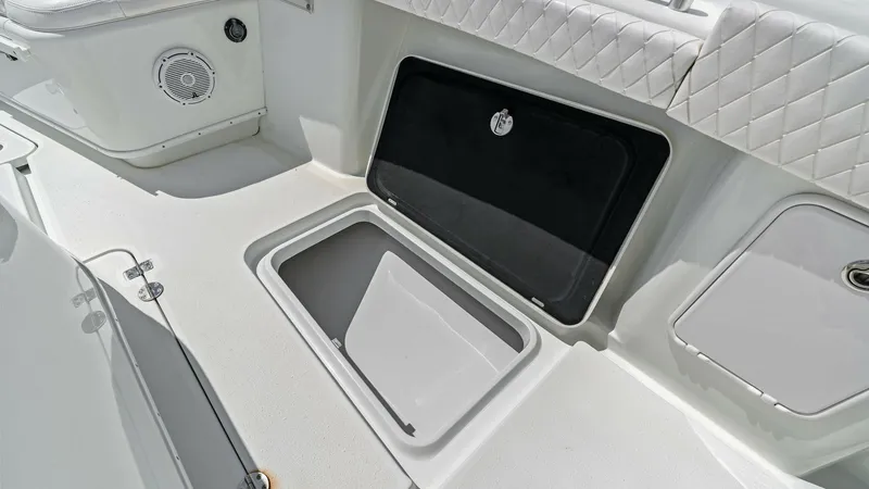 Slide: The Image of Aft Deck Storage Compartment The aft deck of the 2014 Yellowfin 39 Center Console features a spacious storage compartment, perfect for stowing gear and essentials. The deck is equipped with a durable, non-slip surface and showcases a sleek, quilted seating area for added comfort. Int - 7943336