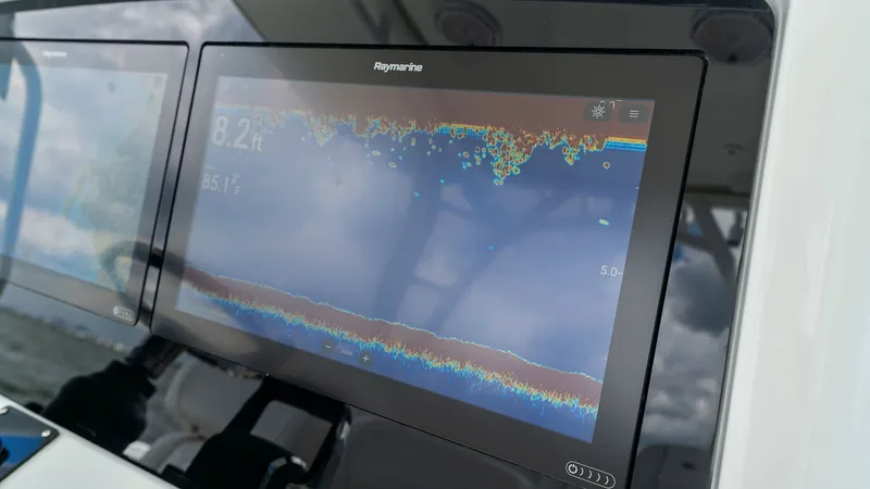 Slide: The Image of Helm Electronics Display Panel The 2014 Yellowfin 39 Center Console features a sophisticated helm with advanced electronic displays. The Raymarine screen provides real-time navigation data and sonar imaging, enhancing the captain's situational awareness. This state-of-the-art setup ens - 7943326