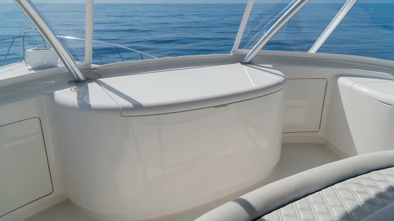 Slide: The Image of Flybridge Seating with Ocean View This image captures the spacious flybridge seating area of the 2014 Viking 66 Convertible. The elegant design features plush, diamond-stitched upholstery, providing comfort and style. The panoramic windows offer breathtaking ocean views, enhancing the lux - 7943401