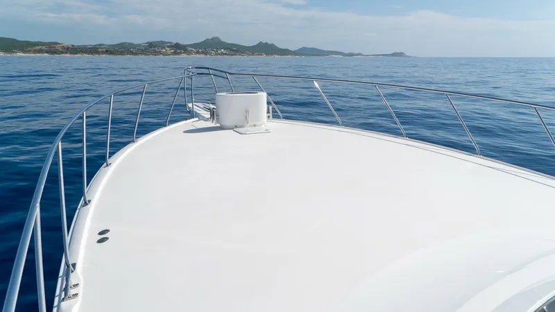 Slide: The Image of Spacious Bow with Ocean View The expansive bow of the 2014 Viking 66 Convertible offers a pristine, open deck space ideal for relaxation and unobstructed ocean views. The sleek lines and polished surfaces reflect the vessel's high-quality craftsmanship. Stainless steel railings add s - 7943393