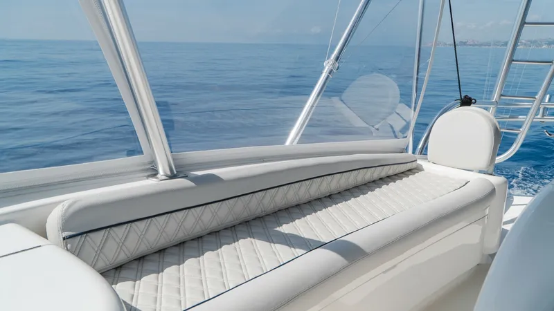 Slide: The Image of Flybridge Seating Area This inviting flybridge seating area on the 2014 Viking 66 Convertible offers a luxurious and comfortable space to enjoy panoramic ocean views. The plush, diamond-stitched upholstery provides both style and comfort, making it an ideal spot for relaxation. - 7943402
