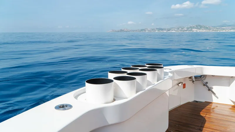 Slide: The Image of Aft Deck with Rocket Launchers The aft deck of the 2014 Viking 66 Convertible 'Billable Hours' features a spacious teak floor with integrated rocket launchers, ideal for avid anglers. The clean, sleek design offers unobstructed views of the open sea, enhancing the fishing and cruising - 7943389