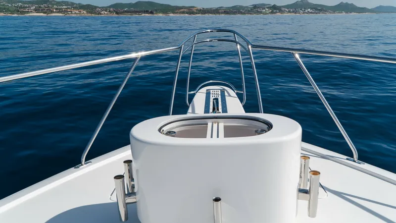 Slide: The Image of Bow with Anchor System The bow of the 2014 Viking 66 Convertible, 'Billable Hours,' showcases a sleek anchor system integrated into the clean, polished deck. Stainless steel rails provide safety while enhancing the vessel's modern aesthetic. This area offers unobstructed views - 7943395