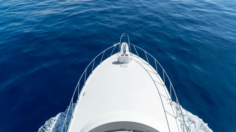 Slide: The Image of Sleek Bow on Open Water The bow of the Viking 66 Convertible, 'Billable Hours', glides smoothly through the serene open waters. This 2014 model showcases the iconic sleek design with sturdy railing and an aerodynamic form that enhances both performance and aesthetic appeal. The - 7943392