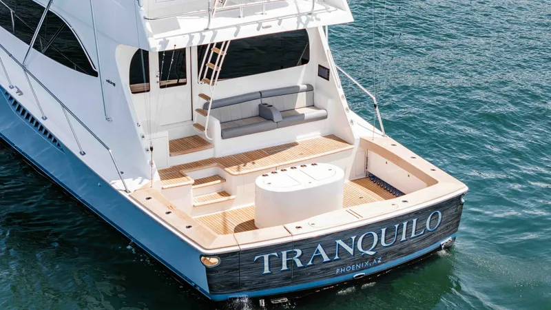 Slide: The Image of 2014 Viking 76 Enclosed Bridge "TRANQUILO" The aft deck of the 2014 Viking 76 Enclosed Bridge Sportfisher, TRANQUILO, features a spacious seating area ideal for relaxation. The well-designed tackle center provides ample storage and functionality for fishing enthusiasts. Teak decking adds a touch o - 7962520