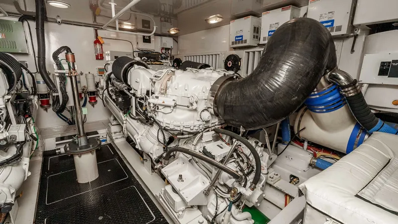 Slide: The Image of 2014 Viking 76 Enclosed Bridge "TRANQUILO" The engine room of the 2014 Viking 76 Enclosed Bridge Sportfisher 'TRANQUILO' showcases dual powerful engines, meticulously maintained and neatly organized. The space features advanced engineering with accessible components for ease of maintenance. Well-l - 7962498