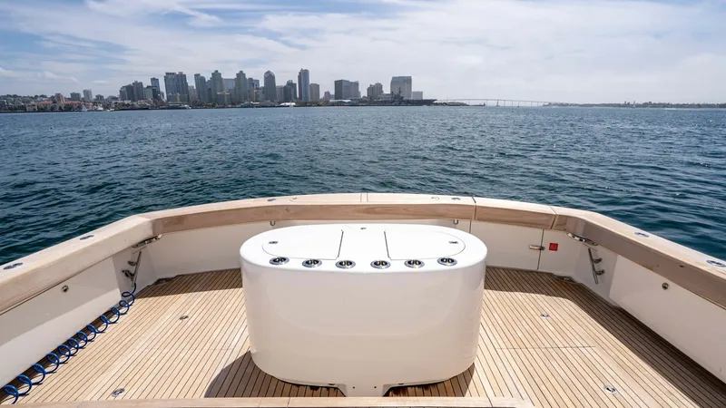Slide: The Image of 2014 Viking 76 Enclosed Bridge "TRANQUILO" The aft deck of the 2014 Viking 76 Enclosed Bridge Sportfisher offers a generous open space ideal for fishing and relaxation. It features a central fishing station equipped with multiple rod holders, surrounded by elegantly crafted teak decking. The unobs - 7962508