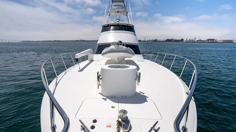 Slide: The Image of 2014 Viking 76 Enclosed Bridge "TRANQUILO" This image showcases the expansive bow deck of the 2014 Viking 76 Enclosed Bridge Sportfisher, TRANQUILO. The deck features a robust anchor system and polished stainless steel railings, offering both functionality and sleek aesthetics. The open space is i - 7962506