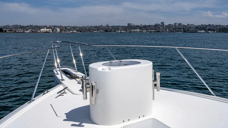 Slide: The Image of 2014 Viking 76 Enclosed Bridge "TRANQUILO" The foredeck of the 2014 Viking 76 Enclosed Bridge Sportfisher showcases a sleek, spacious design perfect for fishing or relaxation. The area features a robust anchor windlass system, ensuring smooth and secure anchoring. Surrounded by stainless steel rai - 7962507