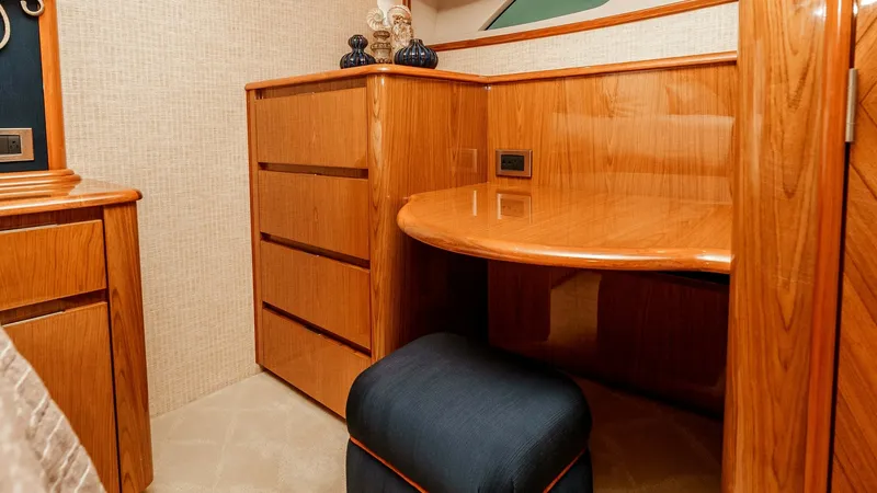 Slide: The Image of 2014 Viking 76 Enclosed Bridge "TRANQUILO" Master Stateroom Vanity This elegant vanity area in the master stateroom of the Viking 76 Enclosed Bridge Sportfisher features rich wood finishes and a sleek, polished surface. Ample storage is provided by the integrated drawers, while the soft lighting and plush seating create - 7962478