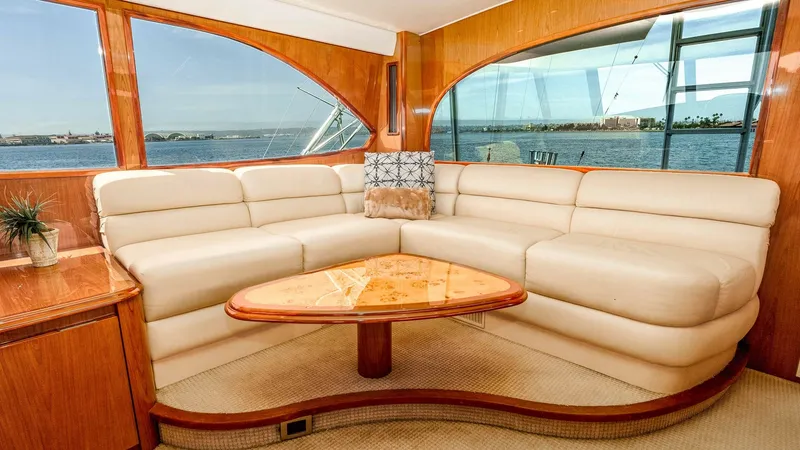 Slide: The Image of 2014 Viking 76 Enclosed Bridge "TRANQUILO" The salon of the 2014 Viking 76 Enclosed Bridge Sportfisher features luxurious leather seating and a beautifully crafted wood table, creating an inviting atmosphere for relaxation. Large windows offer panoramic views, filling the space with natural light - 7962472
