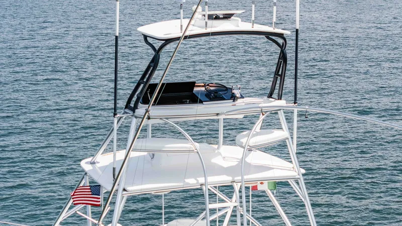 Slide: The Image of 2014 Viking 76 Enclosed Bridge "TRANQUILO" This image showcases the tower helm station on the Viking 76 Enclosed Bridge Sportfisher, featuring state-of-the-art navigation electronics. The open layout provides commanding views of the surroundings, ideal for sportfishing and navigation. The sleek de - 7962515