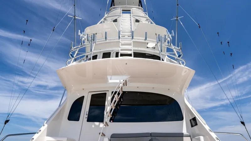 Slide: The Image of 2014 Viking 76 Enclosed Bridge "TRANQUILO" This image showcases the impressive exterior of the Viking 76 Enclosed Bridge Sportfisher, highlighting its towering structure and sleek design. The multiple levels are connected by a sturdy ladder, providing easy access to the upper decks. The clean line - 7962512