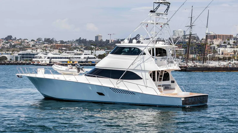 Slide: The Image of 2014 Viking 76 Enclosed Bridge "TRANQUILO" This image showcases the sleek and powerful design of the 2014 Viking 76 Enclosed Bridge Sportfisher, TRANQUILO. The starboard side view highlights the vessel's robust structure and elegant profile, designed for both luxury and high-performance fishing. T - 7962519