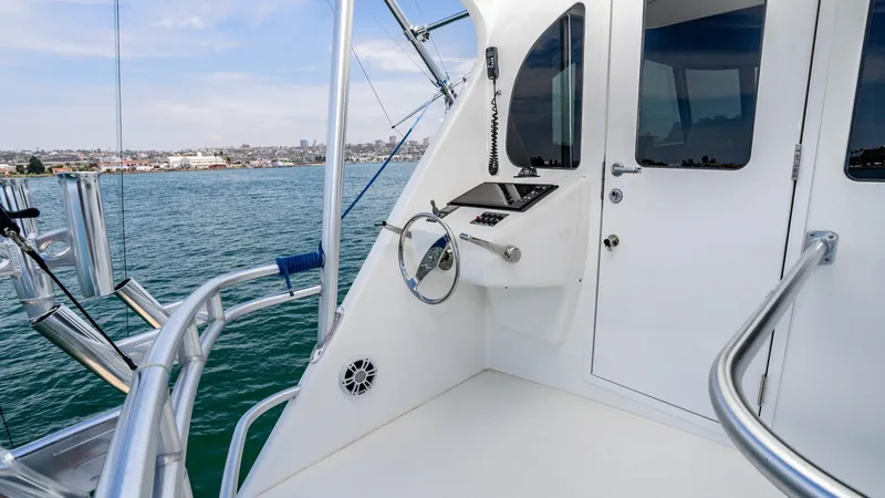 Slide: The Image of 2014 Viking 76 Enclosed Bridge "TRANQUILO" This image showcases the sleek and functional flybridge helm station of the 2014 Viking 76 Enclosed Bridge Sportfisher. The area features a modern steering wheel, advanced navigation controls, and clear visibility, ideal for commanding the vessel with pre - 7962503