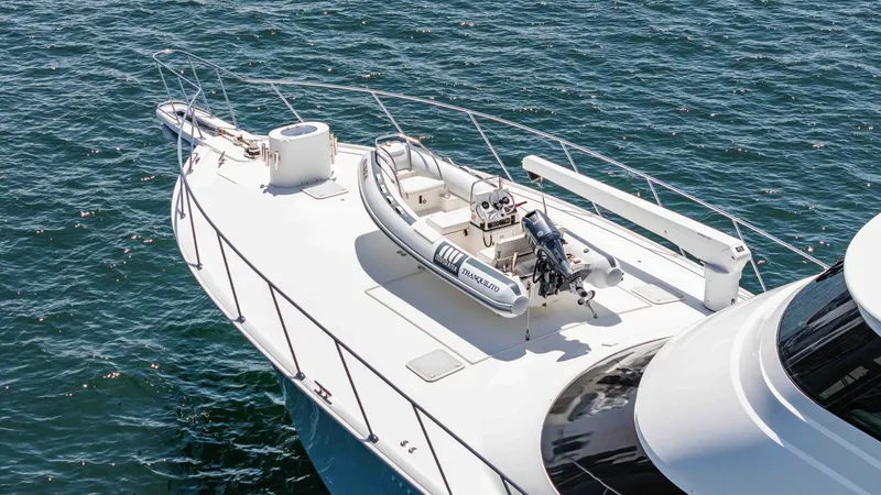 Slide: The Image of 2014 Viking 76 Enclosed Bridge "TRANQUILO" The bow deck of the 2014 Viking 76 Enclosed Bridge Sportfisher features a spacious area with secure storage for a tender. The clean, sleek design emphasizes functionality and ease of access, while the stainless steel railings provide safety and support. T - 7962502