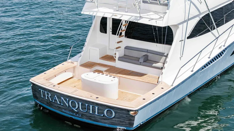 Slide: The Image of 2014 Viking 76 Enclosed Bridge "TRANQUILO" The aft deck of the Viking 76 Enclosed Bridge Sportfisher features a spacious layout with elegant teak flooring. A comfortable built-in bench provides ample seating, perfect for relaxation or socializing. The deck is well-equipped for fishing and leisure, - 7962524