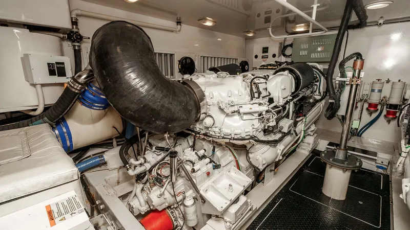 Slide: The Image of 2014 Viking 76 Enclosed Bridge "TRANQUILO" The engine room of the 2014 Viking 76 Enclosed Bridge Sportfisher showcases a well-maintained diesel engine, highlighting the vessel's power and efficiency. The clean and organized space features advanced fuel filtration systems and robust ventilation, en - 7962497