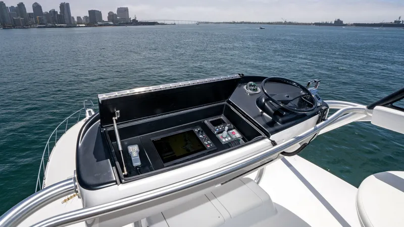 Slide: The Image of 2014 Viking 76 Enclosed Bridge "TRANQUILO" The flybridge helm station of the 2014 Viking 76 Enclosed Bridge Sportfisher offers a commanding view of the horizon. Equipped with advanced navigation systems and ergonomic controls, this area ensures a seamless piloting experience. The sleek design and - 7962505