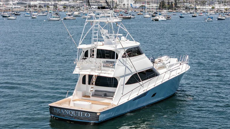 Slide: The Image of 2014 Viking 76 Enclosed Bridge "TRANQUILO" This image showcases the elegant aft view of the 2014 Viking 76 Enclosed Bridge Sportfisher, TRANQUILO. The spacious cockpit is designed for serious fishing pursuits, with ample room and robust construction. The enclosed bridge offers enhanced visibility - 7962523