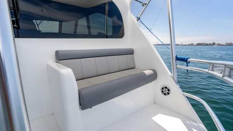 Slide: The Image of 2014 Viking 76 Enclosed Bridge "TRANQUILO" The flybridge of the Viking 76 Enclosed Bridge Sportfisher offers a comfortable seating area with plush gray cushions, perfect for enjoying panoramic ocean views. The sleek design is complemented by stainless steel railings and large windows that enhance - 7962504