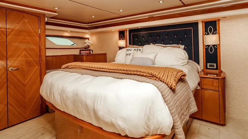 Slide: The Image of 2014 Viking 76 Enclosed Bridge "TRANQUILO" Master Stateroom The master stateroom of the 2014 Viking 76 Enclosed Bridge Sportfisher exudes elegance and comfort with its plush, king-sized bed adorned with premium bedding. Warm wood finishes and subtle lighting create a cozy yet sophisticated atmosphere. Ample storag - 7962477