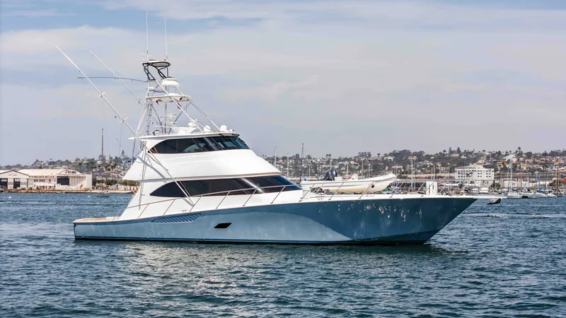 Slide: The Image of 2014 Viking 76 Enclosed Bridge "TRANQUILO" This image showcases the sleek starboard profile of the 2014 Viking 76 Enclosed Bridge Sportfisher, named TRANQUILO. The vessel's modern design is highlighted by its striking blue hull and aerodynamic enclosed bridge, offering both style and functionality - 7962526