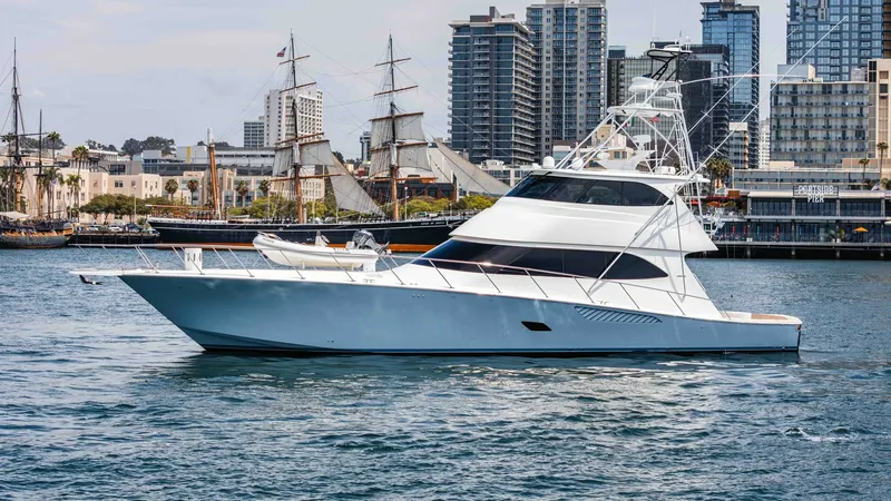 Slide: The Image of 2014 Viking 76 Enclosed Bridge "TRANQUILO" The 2014 Viking 76 Enclosed Bridge Sportfisher, TRANQUILO, is elegantly showcased cruising through a scenic marina backdrop. Its sleek hull design and enclosed bridge provide a harmonious blend of performance and luxury. The vessel's distinctive lines and - 7962517