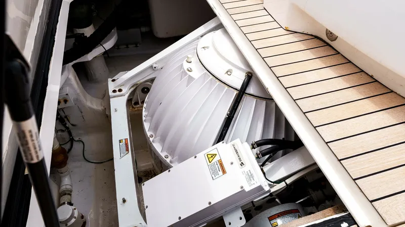 Slide: The Image of 2014 Viking 76 Enclosed Bridge "TRANQUILO" Seakeeper M-21 Gyro Stabilizer Seakeeper M21 Gyro Stabilizer, professionally installed beneath the cockpit sole and accessed through a dedicated service hatch. The gyro provides active stabilization to significantly reduce vessel roll, enhancing comfort while underway or at rest. - 7962510