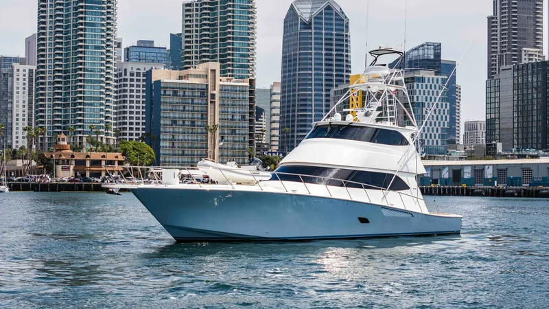 Slide: The Image of 2014 Viking 76 Enclosed Bridge "TRANQUILO" This image showcases the starboard side of the 2014 Viking 76 Enclosed Bridge Sportfisher, TRANQUILO. The sleek hull design and towering enclosed flybridge highlight its impressive engineering and luxury. Set against a backdrop of urban architecture, the - 7962518