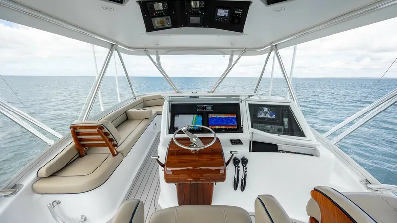Slide: The Image of Flybridge Helm Station The flybridge helm station of the 2008 Winter Custom Yachts 62 Sportfish offers a commanding view with state-of-the-art navigation equipment. The polished wood accents and ergonomic seating enhance both functionality and style. Expansive windows provide a - 7961703