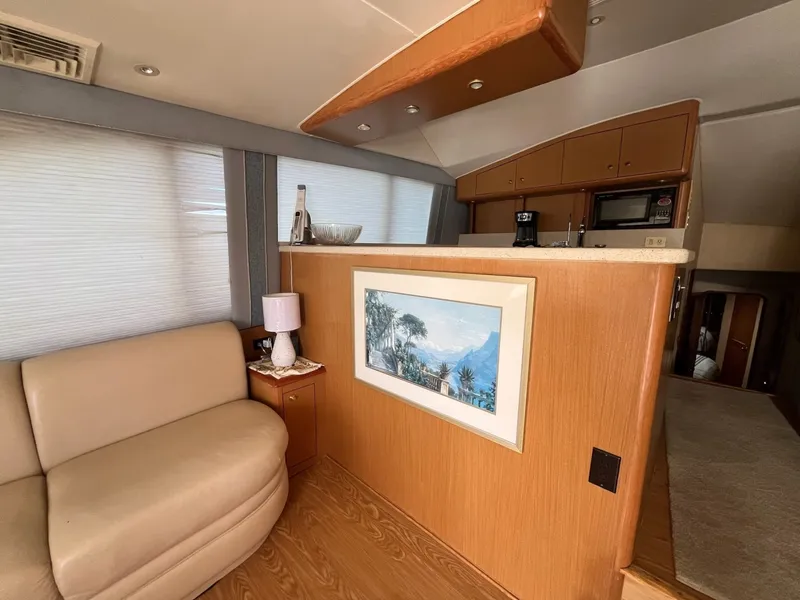 Slide: The Image of Salon Sofa leading into the Galley on the 2004 Ocean Yachts 52 Super Sport - 8036691