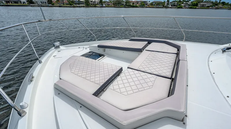 Slide: The Image of Spacious Bow Sunpad Lounge Area The image showcases the luxurious bow sunpad of the 2019 Serenity by Cruisers Yachts, Cantius 46 model. This sunpad offers ample space for relaxation, featuring plush, diamond-stitched cushions that enhance comfort and style. The surrounding stainless-ste - 8141272