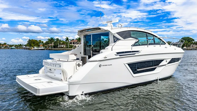 Slide: The Image of Aft View with Swim Platform This image showcases the sleek aft design of the 2019 Cruisers Yachts Cantius 46, featuring a spacious swim platform. The elegant lines and modern styling of the hull are accentuated by large windows, providing ample natural light to the interior. Perfect - 8141288