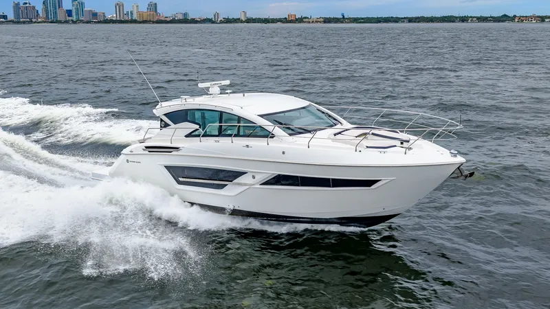 Slide: The Image of Side Profile of Cruisers Cantius 46 The 2019 Cruisers Yachts Cantius 46 showcases a sleek and modern side profile as it glides effortlessly through the water. Its expansive windows provide panoramic views and natural light to the interior, while the aerodynamic hardtop enhances its sporty a - 8141323