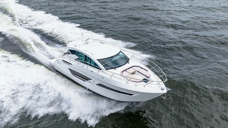 Slide: The Image of Aerial View of Cruising Yacht The 2019 Cruisers Yachts Cantius 46, named 'Serenity', cuts through the water with elegance and power. This aerial shot showcases the sleek, modern design and spacious deck layout, perfect for both leisure and adventure. The vessel's streamlined hull and - 8141321