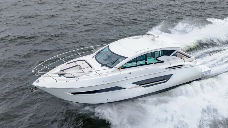 Slide: The Image of Aerial View of Cruising Cantius 46 This aerial shot captures the sleek and modern design of the 2019 Cantius 46 by Cruisers Yachts. The vessel features a spacious foredeck with comfortable sun pads, perfect for relaxing while underway. The streamlined hull and expansive windows enhance the - 8141333