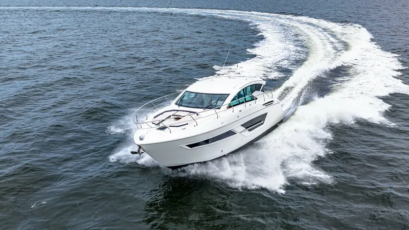 Slide: The Image of Dynamic Aerial View of Serenity Underway This stunning aerial shot captures the 2019 Cruisers Yachts Cantius 46, Serenity, slicing through the water with elegance and power. The sleek, modern design features a streamlined hull and expansive windows, offering unmatched views and natural light ins - 8141328